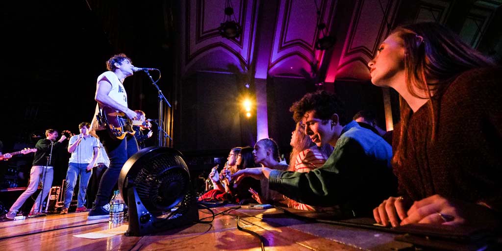 band performing on stage in front of audience